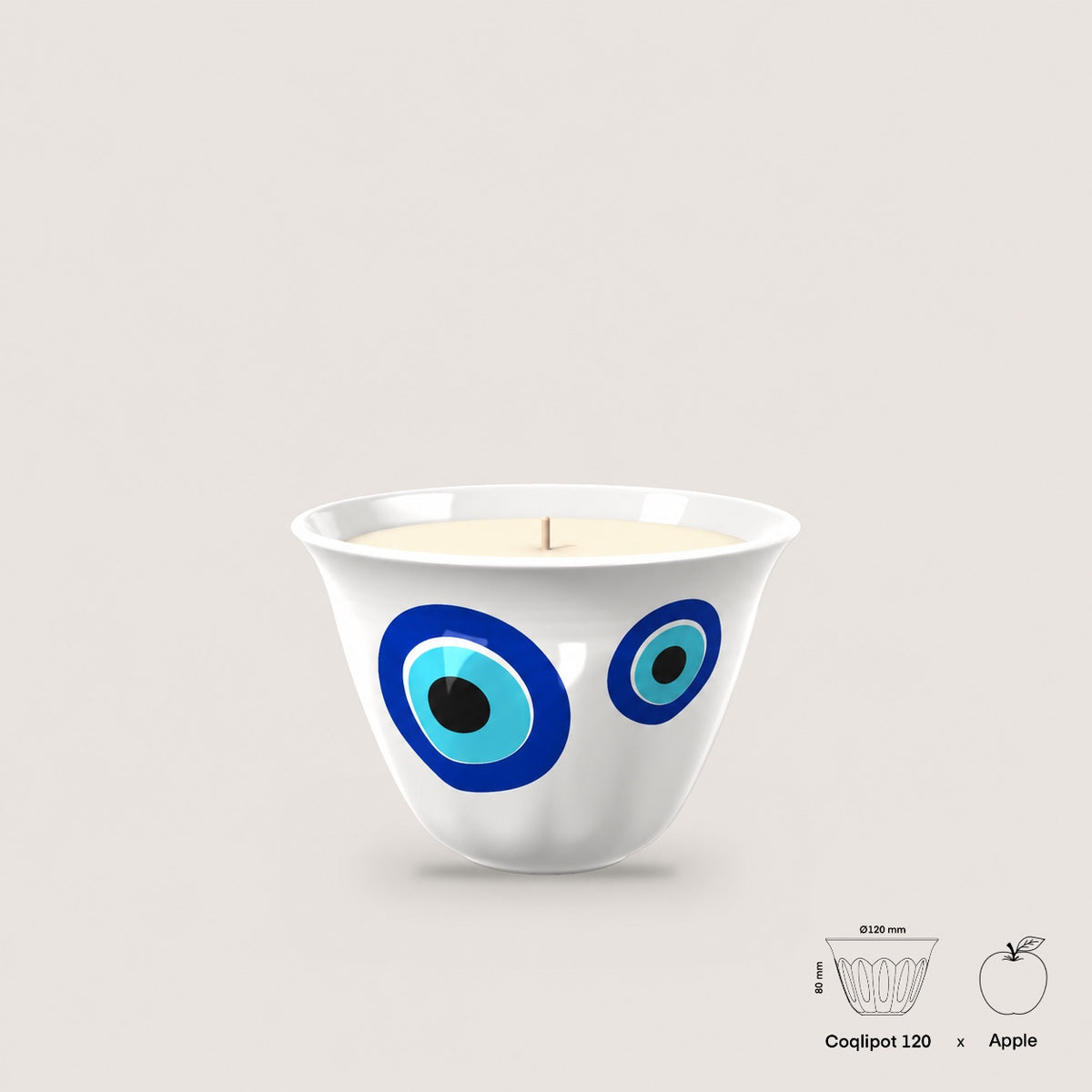 Coqlipot® 120 Kharzé Candle Edition — evil eye (Kharzé) ornament on a cement vessel, single-wick soy-blend wax candle, shown with apple for scale